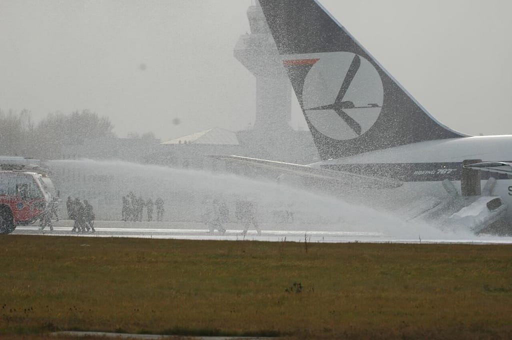Firefighters foam the LOT Flight 16 fuselage