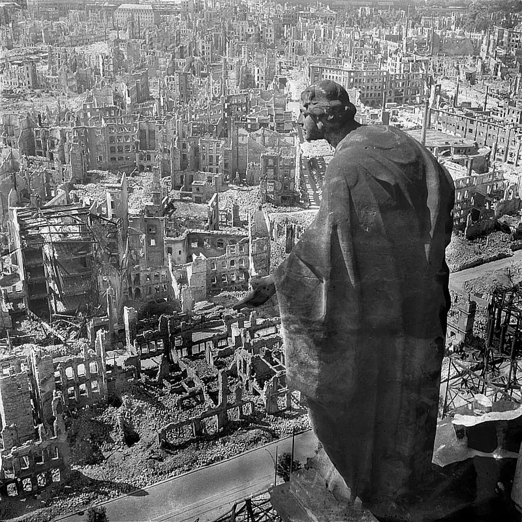 View over ruined Dresden from the Rathaus tower, with a stone statue in the foreground