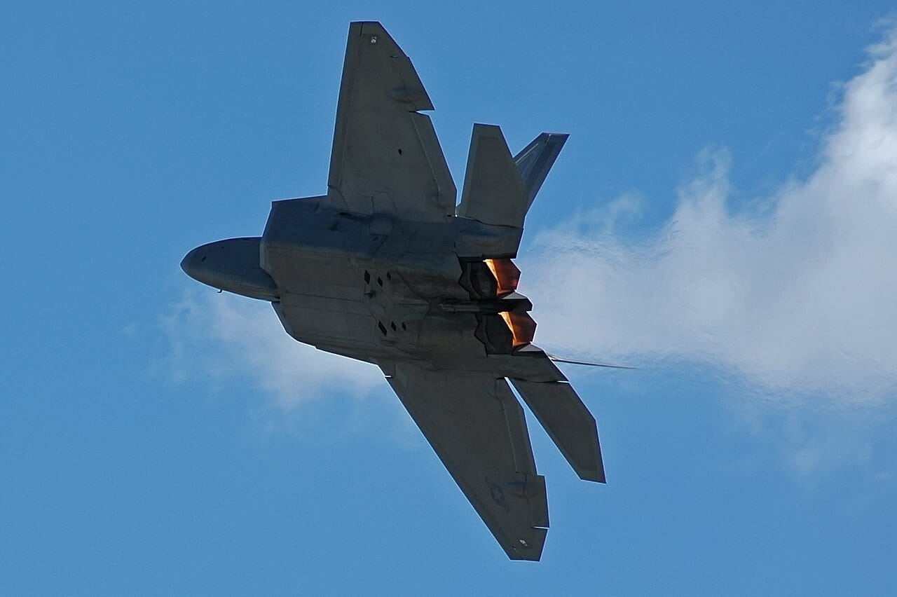 F-22A Raptor stealth fighter with afterburner lit during night operations